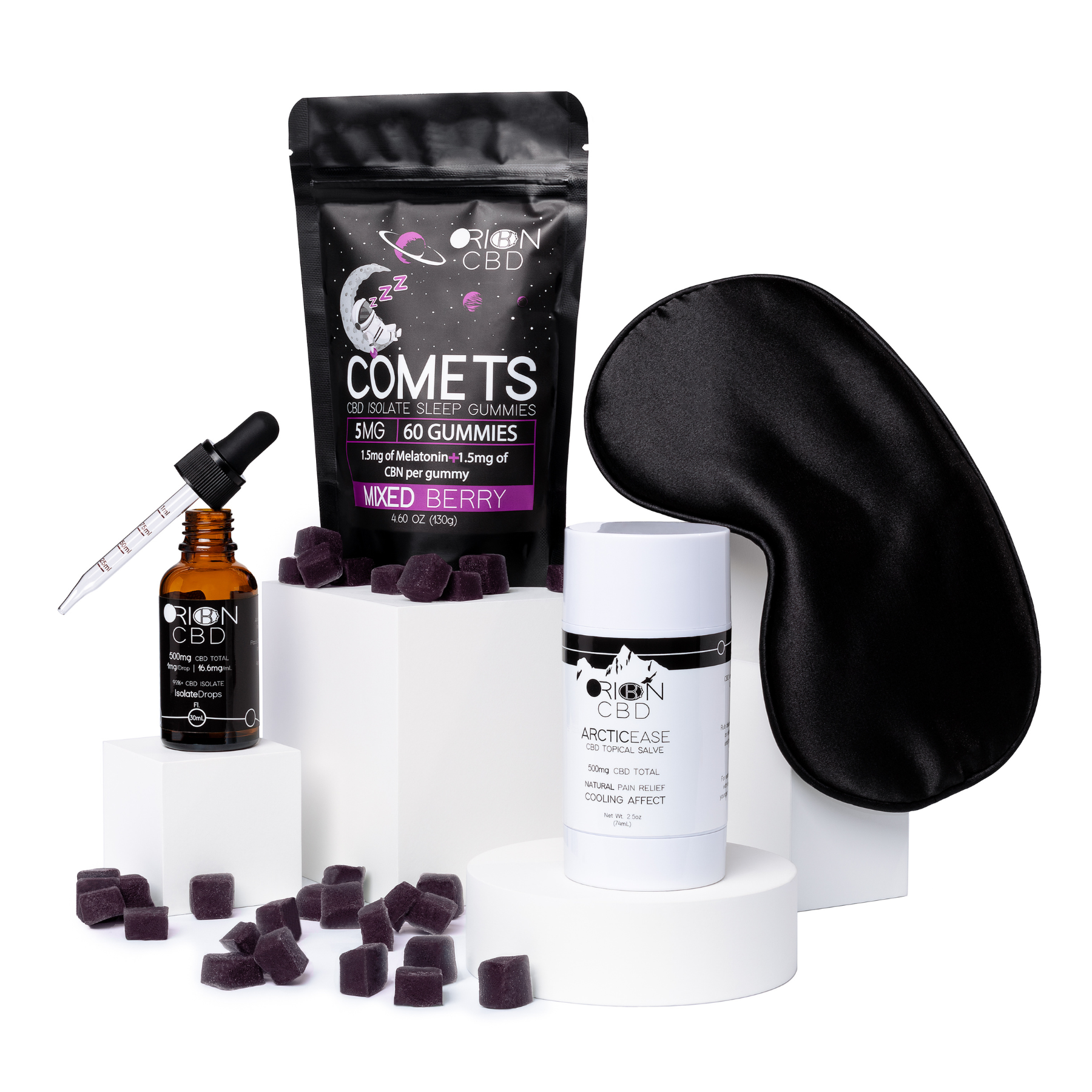 Orion CBD Deep Sleep Bundle featuring Isolate Drops, Sleep Gummies in mixed berry flavor, and Pain Relief Salve Stick on white blocks with scattered sleep gummies and a sleep mask hanging off one block